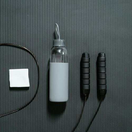 Minimalist yoga accessories on dark floor